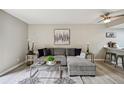 Open living room featuring an L-shaped sofa and a view of the kitchen at 4274 S Salida Way # 6, Aurora, CO 80013