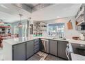 Well-lit kitchen boasts gray cabinets, stainless appliances, white countertops, and recessed lighting at 6311 Xavier St, Arvada, CO 80003