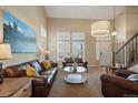Spacious living room with large windows, comfortable leather seating, and stylish decor at 2861 Madison Ln, Broomfield, CO 80023