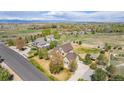 Expansive property featuring a well-maintained home, complemented by sprawling lawns, mature trees and mountain views at 3225 Rinn Valley Dr, Longmont, CO 80504