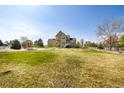 Expansive backyard with lush green lawn, white fencing, and ample space for outdoor activities at 3225 Rinn Valley Dr, Longmont, CO 80504