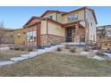 Charming two-story home with stone accents, covered porch, and well-manicured lawn at 7897 S Jamestown Ct, Aurora, CO 80016