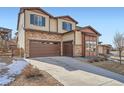 Lovely two-story home featuring stone accents, a spacious garage and a long drive way at 7897 S Jamestown Ct, Aurora, CO 80016