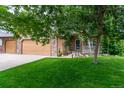 Inviting view of a home's exterior featuring a well-maintained lawn and three-car attached garage at 424 Arbor Dr, Lafayette, CO 80026