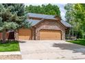 Spacious home featuring an attached three-car garage with stone facade and ample driveway space at 424 Arbor Dr, Lafayette, CO 80026