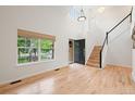 Bright foyer with hardwood floors, high ceilings, staircase, and large window offering natural light at 424 Arbor Dr, Lafayette, CO 80026