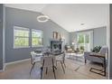 Open-concept living and dining room featuring a fireplace, lots of light and stylish modern decor at 360 S Estes St # C, Lakewood, CO 80228