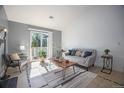 Cozy living room with a sliding glass door, natural lighting and stylish decor at 360 S Estes St # C, Lakewood, CO 80228
