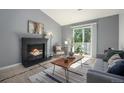 Cozy living room featuring a fireplace, comfortable seating, and a stylish coffee table at 360 S Estes St # C, Lakewood, CO 80228