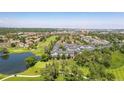 Aerial view showcasing the townhomes with a golf course, pond, and scenic neighborhood at 2945 W Riverwalk Cir # B, Littleton, CO 80123