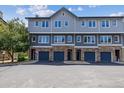 Attractive multi-story townhomes with stone accents and private garages for residents at 2945 W Riverwalk Cir # B, Littleton, CO 80123