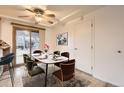 Cozy dining area with a ceiling fan, table with seating for six, and sliding glass door to outdoor space at 367 Jupiter Dr, Lone Tree, CO 80124