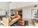 Cozy living area with fireplace, staircase, and open layout at 8165 E Lowry Blvd # 310, Denver, CO 80230