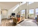 Open-concept living room boasts vaulted ceilings and a cozy fireplace at 8165 E Lowry Blvd # 310, Denver, CO 80230