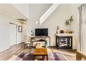 Comfortable living room with fireplace, wood floors, and natural light at 8165 E Lowry Blvd # 310, Denver, CO 80230