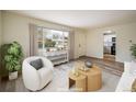 Cozy living room featuring a white chair, round table, and a large window allowing lots of natural light at 740 Lotus Way, Broomfield, CO 80020