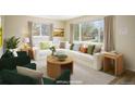 Bright, staged living room features large windows, neutral walls, and plush furnishings, creating an inviting space at 740 Lotus Way, Broomfield, CO 80020