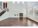 Bright living room with hardwood floors, a stone fireplace, and large windows at 7838 W Layton Way, Littleton, CO 80123