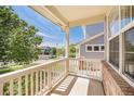 Inviting front porch area offering a cozy outdoor space to enjoy the neighborhood views at 15901 E 106Th Way, Commerce City, CO 80022
