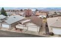 Aerial view of a cozy home with a garage, surrounded by a well-kept neighborhood and mountain views at 23 Carla Way, Broomfield, CO 80020