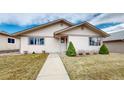 Charming single-story home with a walkway leading to the front door and manicured shrubs at 23 Carla Way, Broomfield, CO 80020