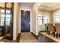 Welcoming entryway features a dark wood door, hardwood floors, and views into the dining room at 1152 S Ogden St, Denver, CO 80210