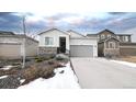 Two-story home with gray garage door and stone accents at 20 Vista Canyon Dr, Castle Rock, CO 80104