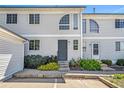 Two story condo featuring light siding, front yard landscaping, and reserved parking at 5145 W 61St Dr # 14, Arvada, CO 80003