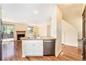 Open-concept view of the living room with a fireplace and sliding doors to the outside at 5145 W 61St Dr # 14, Arvada, CO 80003