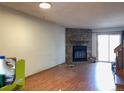 View of living room area with wood-style floors and fireplace at 8181 S Fillmore Cir, Centennial, CO 80122