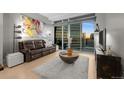 Cozy living room featuring modern art and an entertainment center, providing comfort and style at 2001 Lincoln St # 2412, Denver, CO 80202