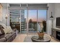 The living room provides gorgeous views of the city from this unit's private balcony at 2001 Lincoln St # 2412, Denver, CO 80202