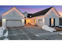 Modern farmhouse exterior boasts a welcoming front porch and two-car garage at 14319 Hop Clover St, Parker, CO 80134