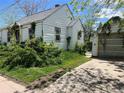 Backyard view of a charming single-Gathering home, with detached garage and small yard at 54 E Cornell Ave, Englewood, CO 80113