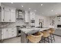Elegant kitchen featuring a granite-topped island with seating and stainless steel appliances, perfect for modern living at 536 Cook St, Denver, CO 80206