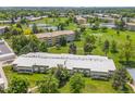 Scenic aerial view of the community with golf course, lake, and multiple residential buildings at 9320 E Center Ave # 4B, Denver, CO 80247