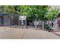 Gated entrance to The Overlook condos at 2525 and 2501 with mature trees and landscaping at 1521 Central St # 2D, Denver, CO 80211