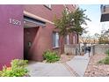 Brick condominium exterior, #1521, with xeriscaped garden and pathway at 1521 Central St # 2D, Denver, CO 80211