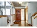 Inviting foyer with wood flooring, closet, and decorative glass door panel at 3820 S Ames St, Denver, CO 80235