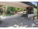 Exterior building entrance with covered drive through and mature landscaping at 2375 S Linden Ct # 201, Denver, CO 80222