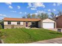Charming single-story home with a well-maintained lawn, brick facade, attached garage and inviting curb appeal at 16246 E Hamilton Pl, Aurora, CO 80013