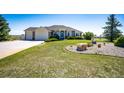 Beautiful home showcasing a well-maintained lawn, mature landscaping, and a long driveway at 34942 Wagon Wheel Trl, Elizabeth, CO 80107