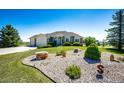 Attractive ranch-style home with an expansive lawn, mature trees, and rock garden at 34942 Wagon Wheel Trl, Elizabeth, CO 80107