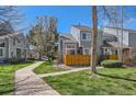 Charming two-story home with a well-manicured lawn and a wooden fence, nestled in a tranquil neighborhood at 5128 Buckingham Rd, Boulder, CO 80301