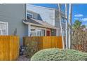 Charming two-story home with a covered porch and a wooden fence, perfect for relaxing outdoors at 5128 Buckingham Rd, Boulder, CO 80301
