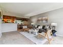 Comfortable living area with stylish furniture flowing into the dining space and kitchen at 9283 E Arbor Cir # C, Englewood, CO 80111