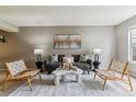 The spacious living room offers a modern aesthetic with a plush sofa, accent chairs, and contemporary decor at 9283 E Arbor Cir # C, Englewood, CO 80111
