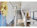 Elegant foyer with hardwood floors, a staircase, and a view into the dining room at 2937 W Yarrow Cir, Superior, CO 80027