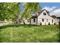 Spacious lawn surrounds this bright home featuring a mix of modern updates and classic design at 1980 S Kearney Way, Denver, CO 80224