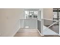 Bright hallway boasting hardwood floors, modern railings, and large windows with neighborhood views at 3127 S Russell St, Morrison, CO 80465